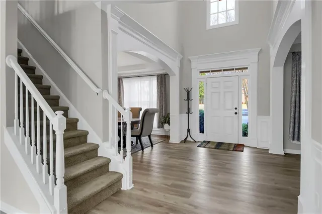 a view of an entryway with wooden floor and stairs