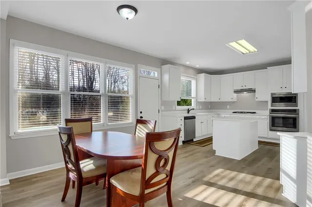 a view of a dining room with furniture and wooden floor