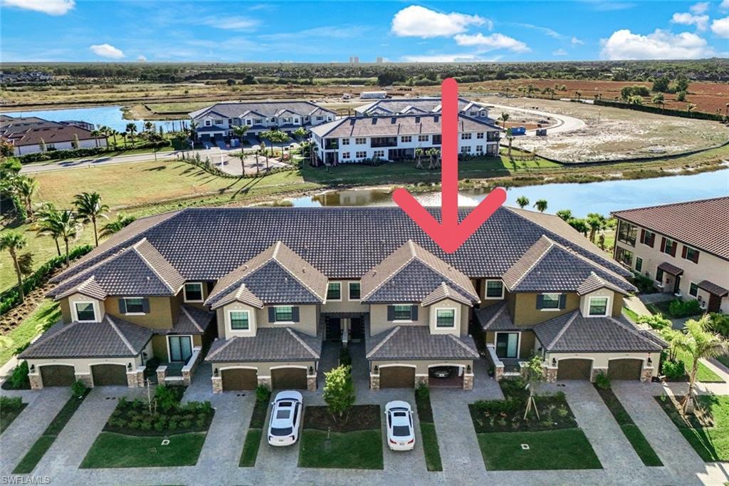 15336 Lucerna Street, Unit 203 Naples, FL 34114 - Photo 26 of 33 Aerial view of residential area with a large body of water