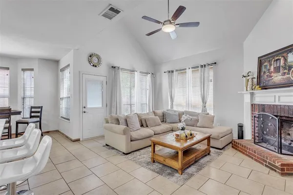 a living room with furniture and a fireplace