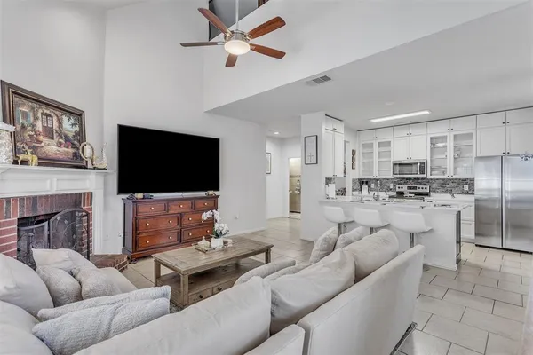 a living room with fireplace furniture and a flat screen tv