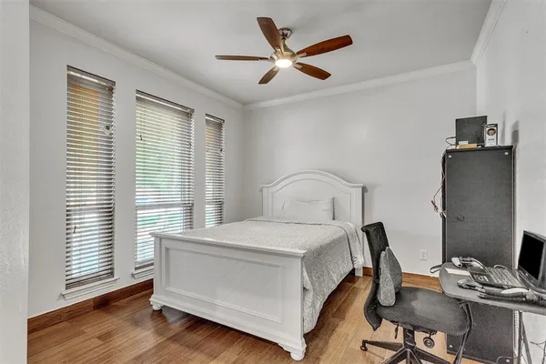 a bedroom with a bed and a desk in it