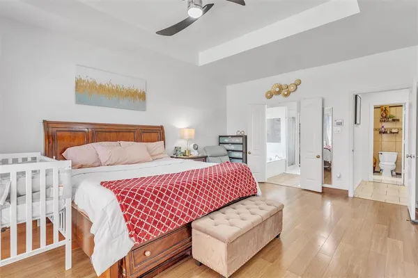 a bedroom with bed and wooden floor