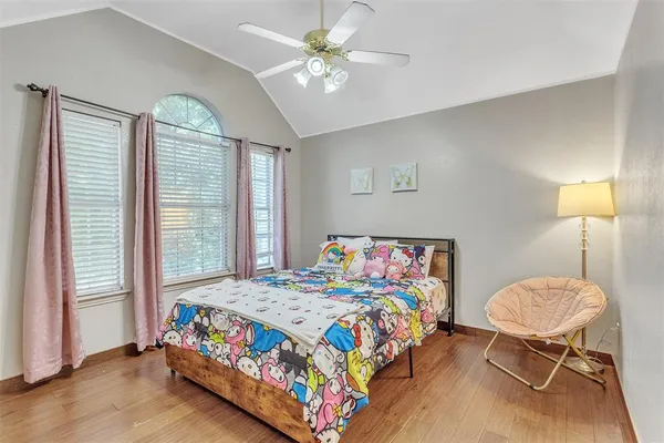 a bedroom that has a bed and a chair in it