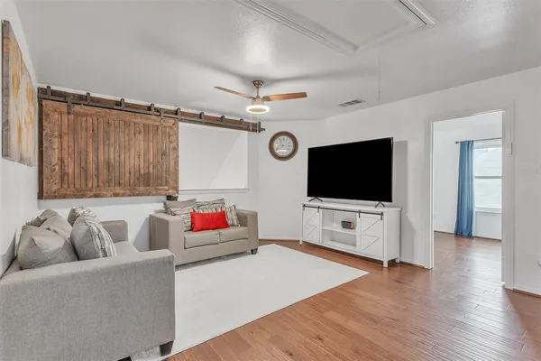 a living room with furniture and a flat screen tv