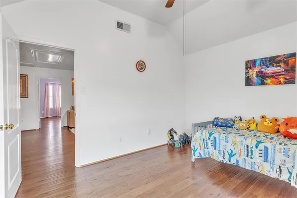 a view of a baby room with furniture and wooden floor