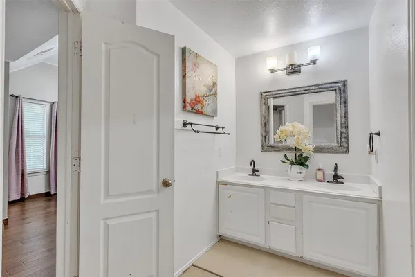 a bathroom with a double vanity sink and a mirror