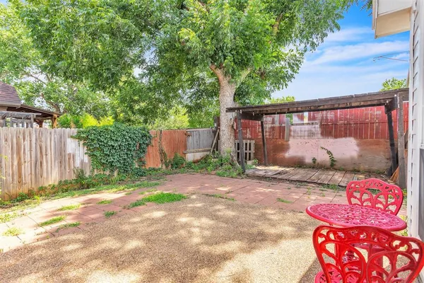 a backyard of a house with barbeque oven