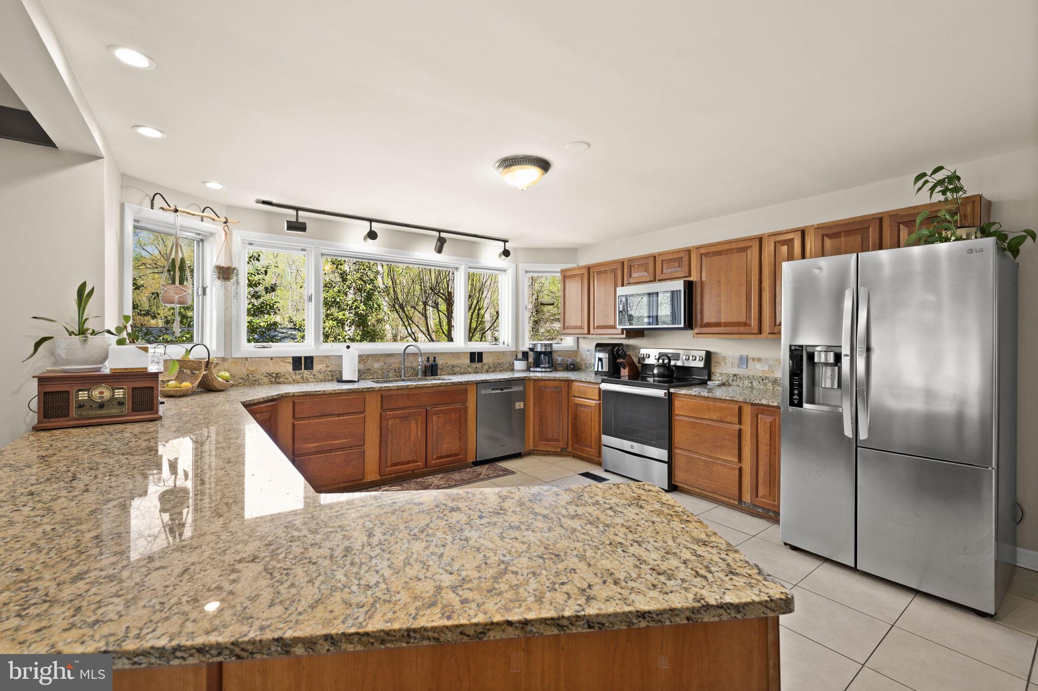 111 Chesterfield Court Locust Grove, VA 22508 - Photo 24 of 97 a kitchen with stainless steel appliances granite countertop a stove refrigerator and sink