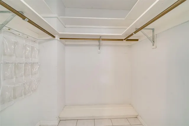 a living room with furniture a flat screen tv and a window