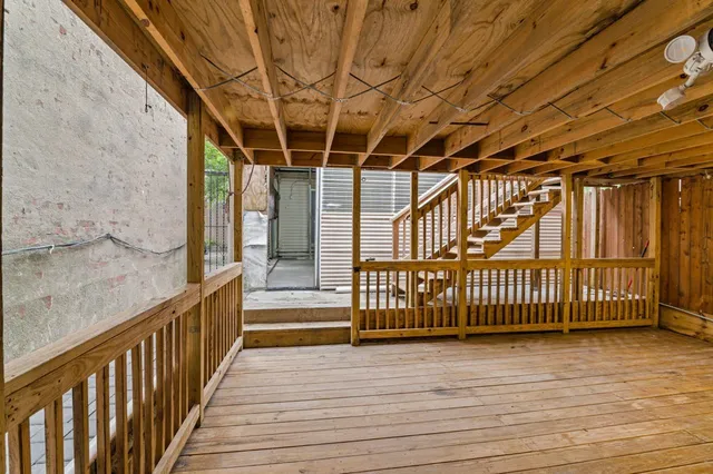 a view of a porch with wooden floor and fence