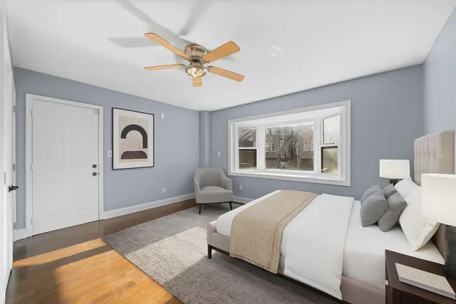 a spacious bedroom with a bed and a window