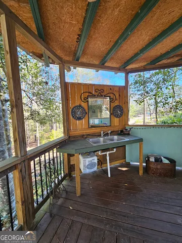 a room with wooden floor table and chairs