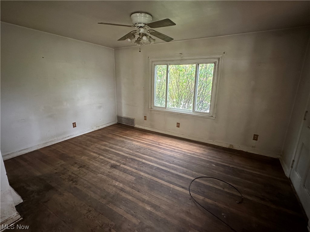 176 East Wilbeth Road Akron, OH 44301 - Photo 9 of 17 Spare room with dark hardwood floors and ceiling fan