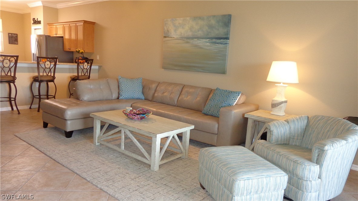 8261 Pathfinder Loop, Unit 745 Fort Myers, FL 33919 - Photo 1 of 20 a living room with furniture and a lamp