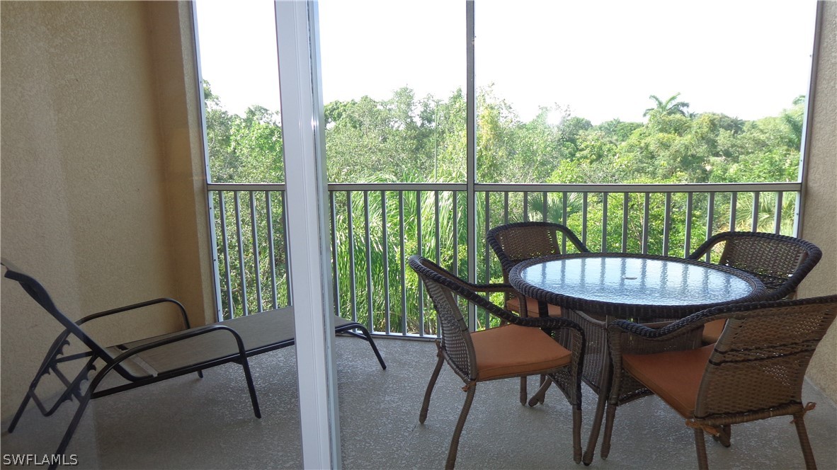 8261 Pathfinder Loop, Unit 745 Fort Myers, FL 33919 - Photo 13 of 20 a view of a chair and table in the balcony