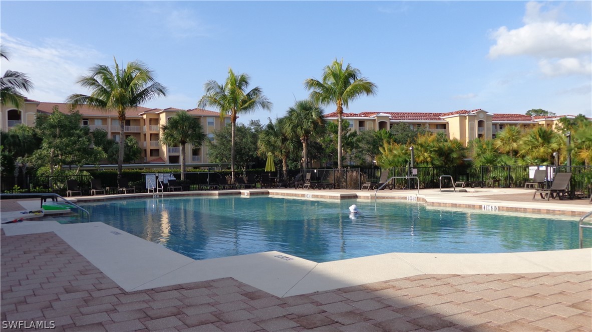 8261 Pathfinder Loop, Unit 745 Fort Myers, FL 33919 - Photo 17 of 20 a view of a swimming pool and a chair