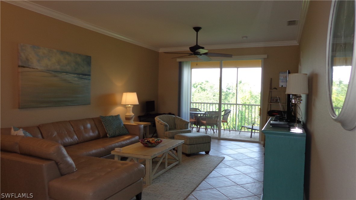 8261 Pathfinder Loop, Unit 745 Fort Myers, FL 33919 - Photo 2 of 20 a living room with furniture and a flat screen tv