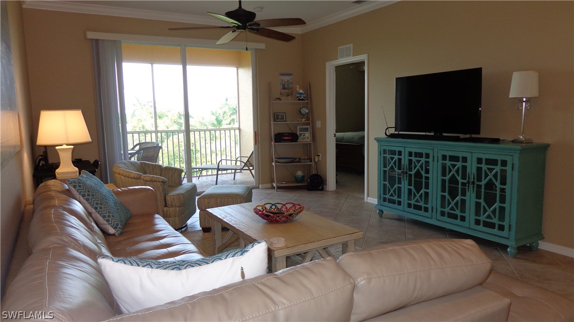 8261 Pathfinder Loop, Unit 745 Fort Myers, FL 33919 - Photo 3 of 20 a living room with furniture and a flat screen tv