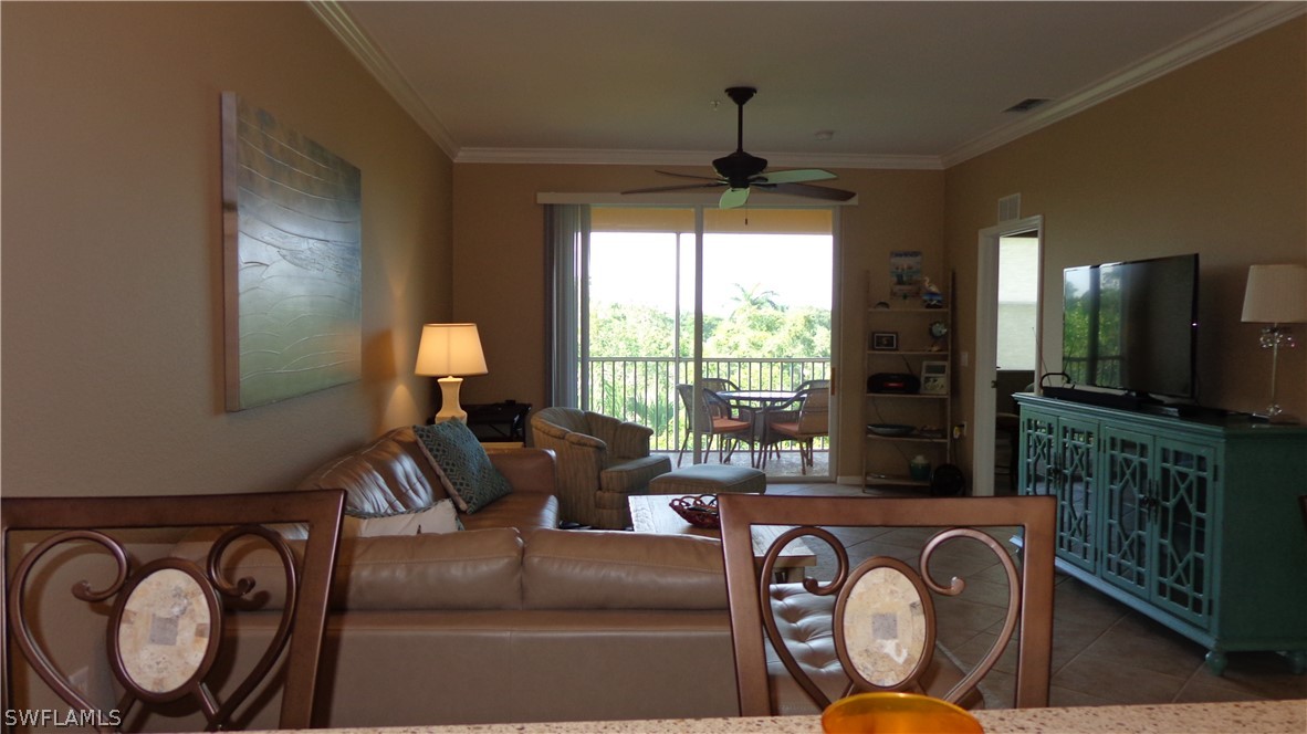8261 Pathfinder Loop, Unit 745 Fort Myers, FL 33919 - Photo 4 of 20 a living room with furniture and a flat screen tv