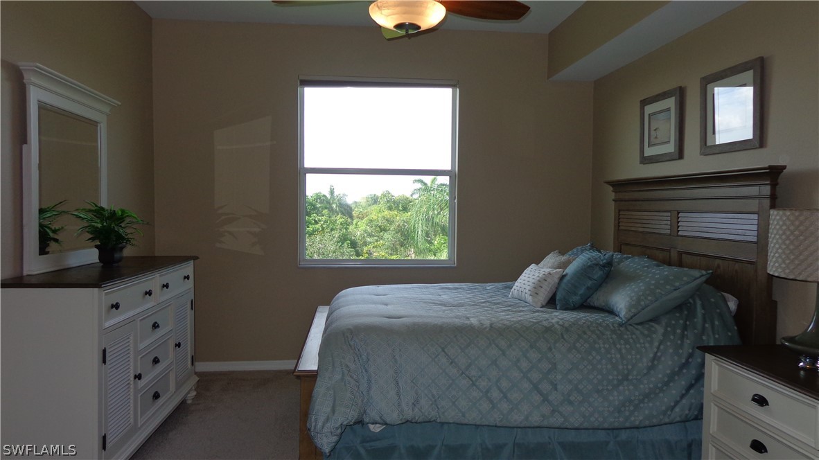 8261 Pathfinder Loop, Unit 745 Fort Myers, FL 33919 - Photo 7 of 20 a bedroom with a bed and a dresser