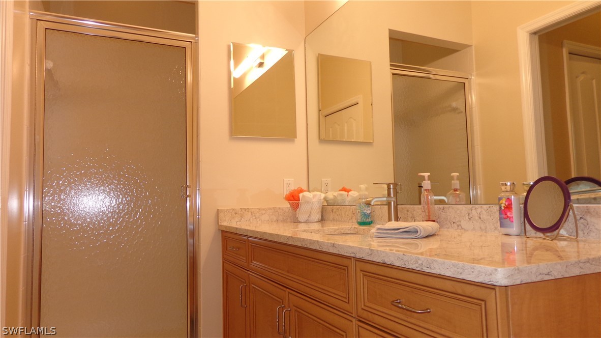 8261 Pathfinder Loop, Unit 745 Fort Myers, FL 33919 - Photo 8 of 20 a bathroom with a sink and a mirror