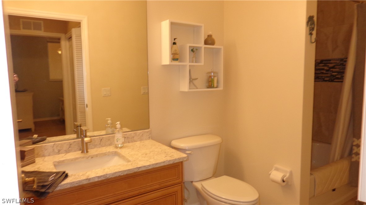 8261 Pathfinder Loop, Unit 745 Fort Myers, FL 33919 - Photo 10 of 20 a bathroom with a sink a toilet and shower