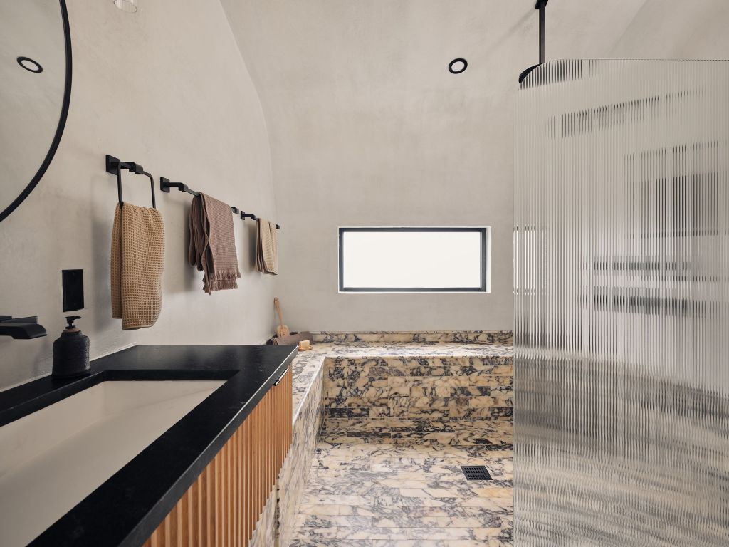 2201 Garden Street Austin, TX 78702 - Photo 23 of 40 a bathroom with a granite countertop sink a mirror and shower