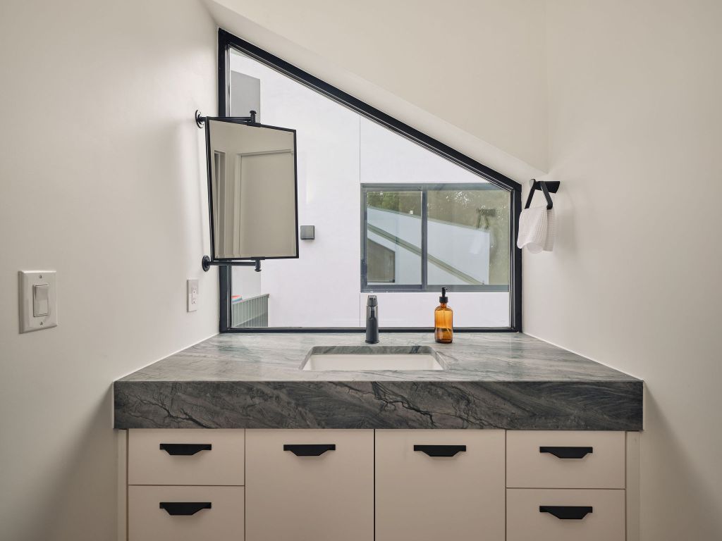 2201 Garden Street Austin, TX 78702 - Photo 32 of 40 a kitchen with granite countertop a sink and a stove
