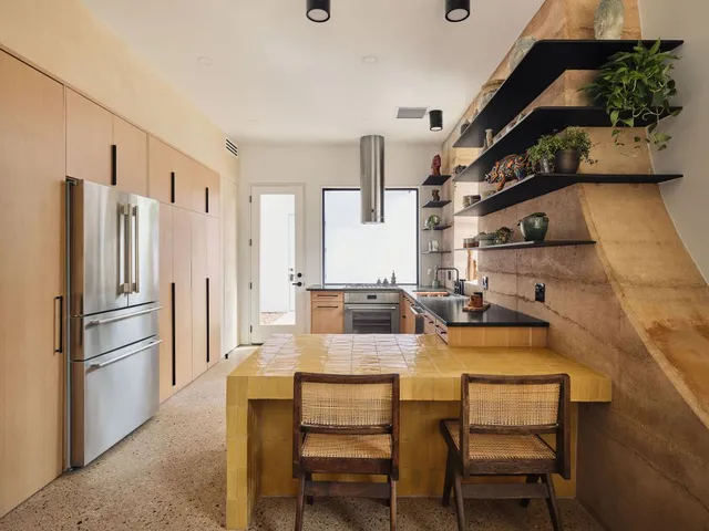 a dining room with furniture and a kitchen view
