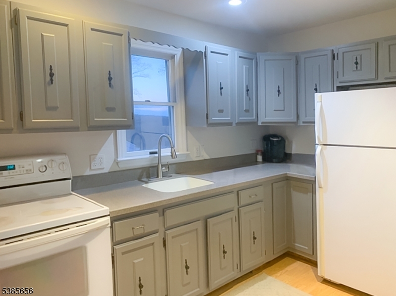 5 Geneva Trail Hopatcong, NJ 07843 - Photo 3 of 9 a kitchen with a sink and a refrigerator