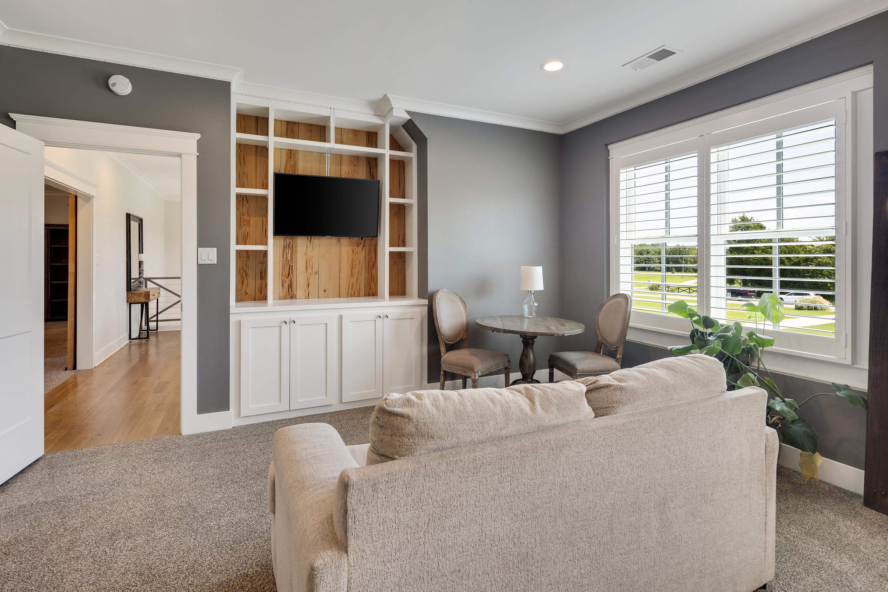 805 Shady Grove Road Williston, TN 38076 - Photo 29 of 40 Built-in media center with wood-finish backing and white cabinetry, recessed lighting, crown molding, and plantation shutters