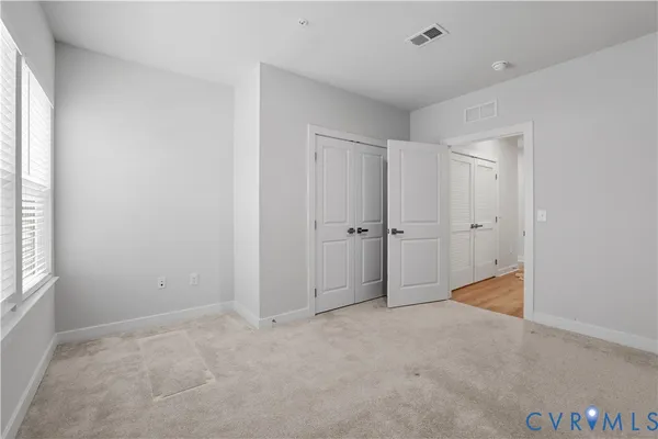 a view of a balcony with wooden floor and fence