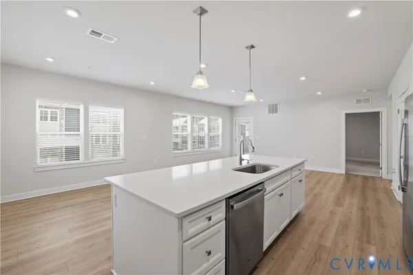 a kitchen with stainless steel appliances a sink stove and refrigerator