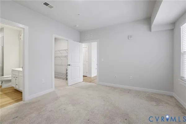 a bathroom with a double vanity sink toilet mirror and shower