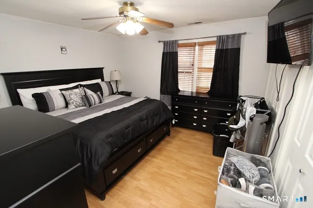 a bedroom with a bed and a flat tv screen