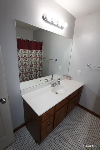 a bathroom with a sink vanity and a mirror