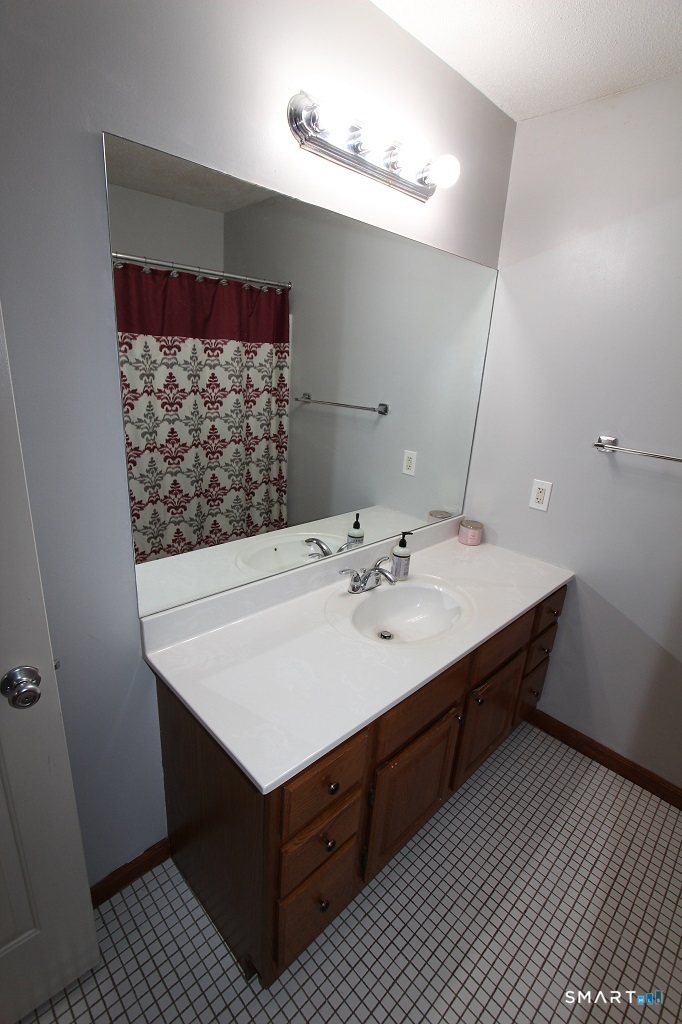 380 Hitchcock Road, Unit 47 Waterbury, CT 06705 - Photo 16 of 21 a bathroom with a sink vanity and a mirror