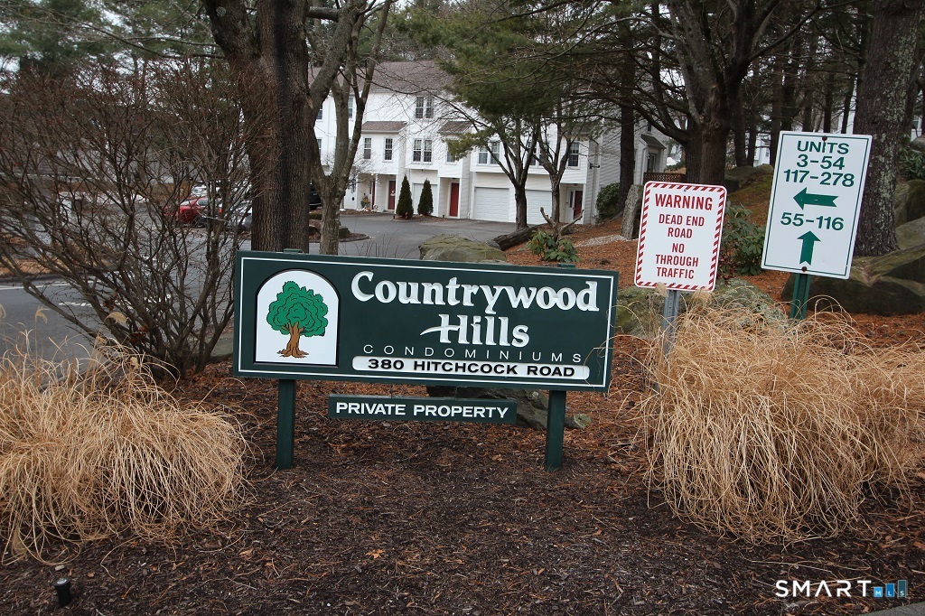 380 Hitchcock Road, Unit 47 Waterbury, CT 06705 - Photo 21 of 21 a view of a street sign board with large trees