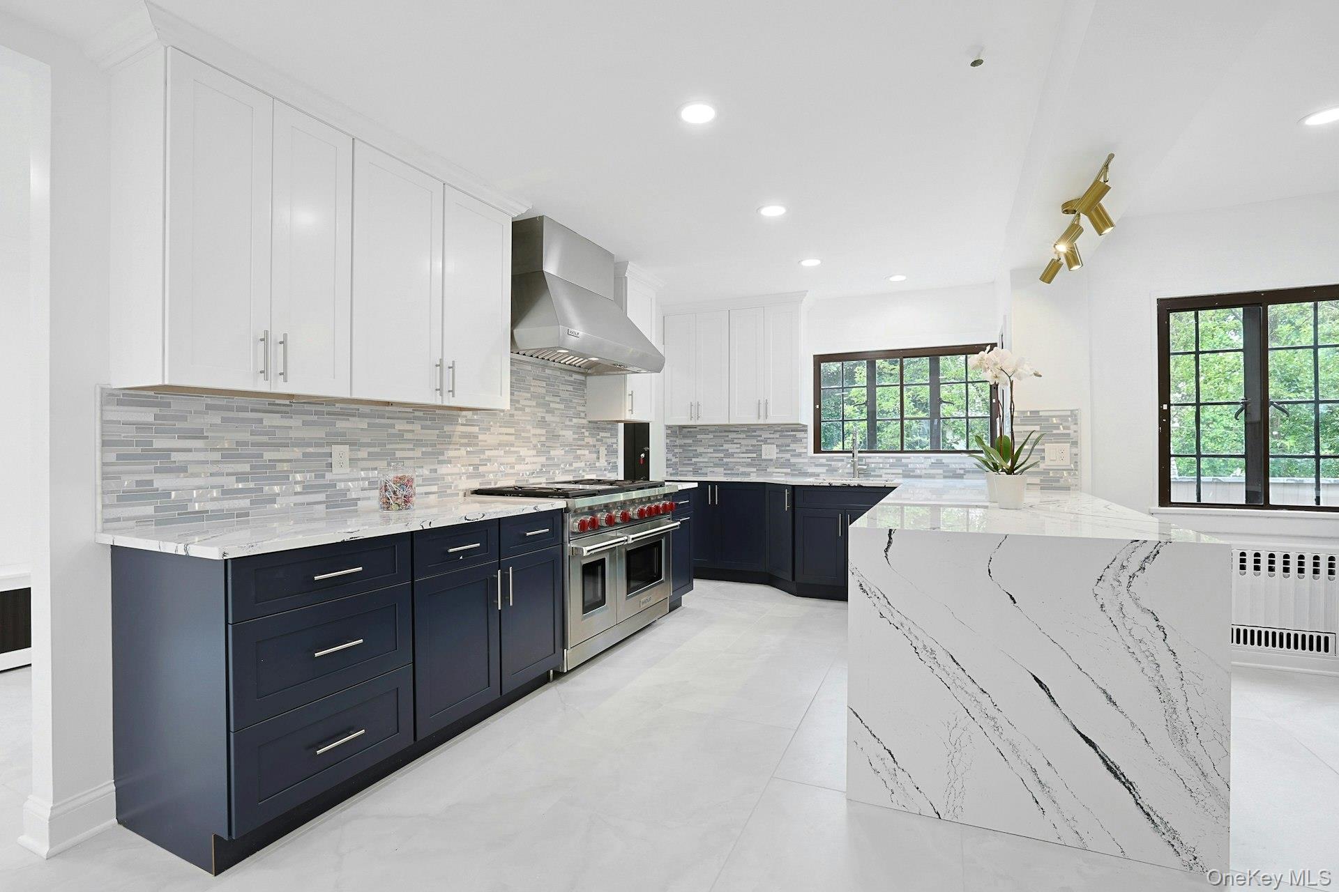 14 Withington Road Scarsdale, NY 10583 - Photo 12 of 41 a large white kitchen with kitchen island white cabinets and stainless steel appliances