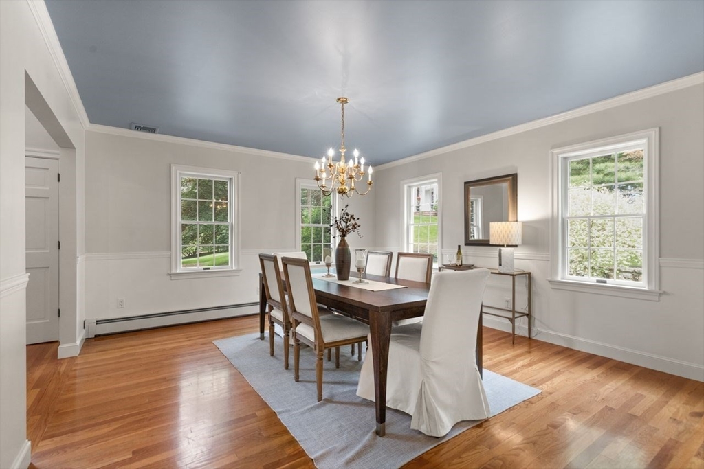 9 Mohawk Lane Lynnfield, MA 01940 - Photo 11 of 42 a dining room with furniture a chandelier and wooden floor