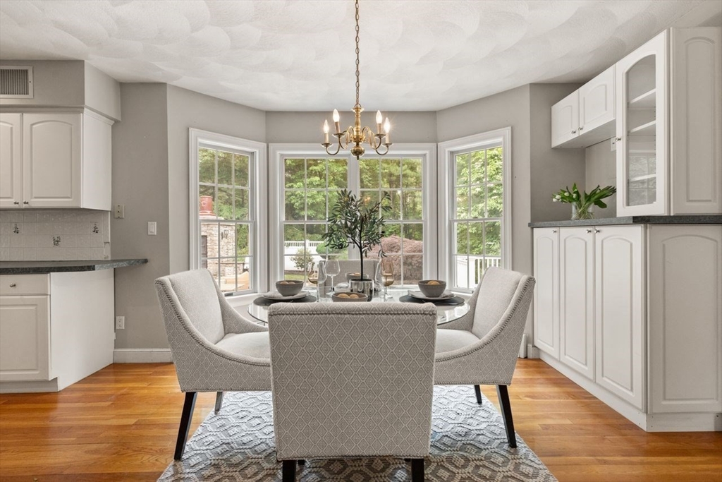 9 Mohawk Lane Lynnfield, MA 01940 - Photo 12 of 42 a dining room with furniture a chandelier and wooden floor