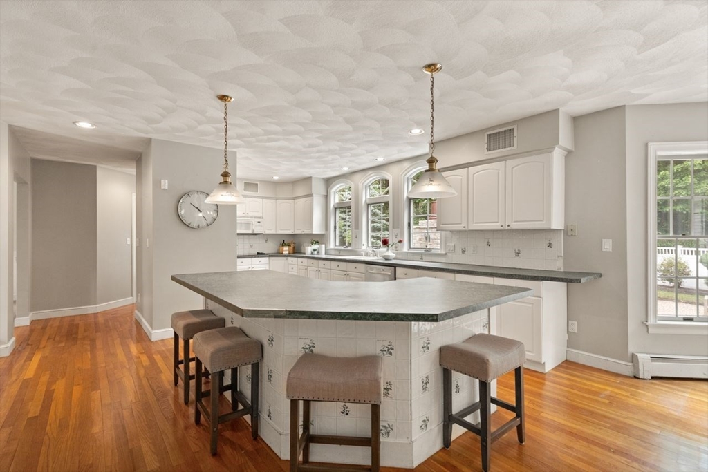 9 Mohawk Lane Lynnfield, MA 01940 - Photo 14 of 42 a kitchen with stainless steel appliances kitchen island a chandelier