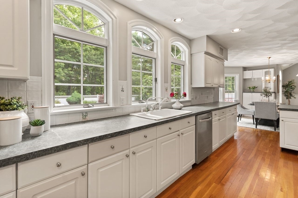 9 Mohawk Lane Lynnfield, MA 01940 - Photo 18 of 42 a large white kitchen with granite countertop a large window a sink and white appliances