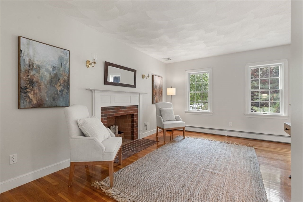 9 Mohawk Lane Lynnfield, MA 01940 - Photo 20 of 42 a living room with furniture and a fireplace