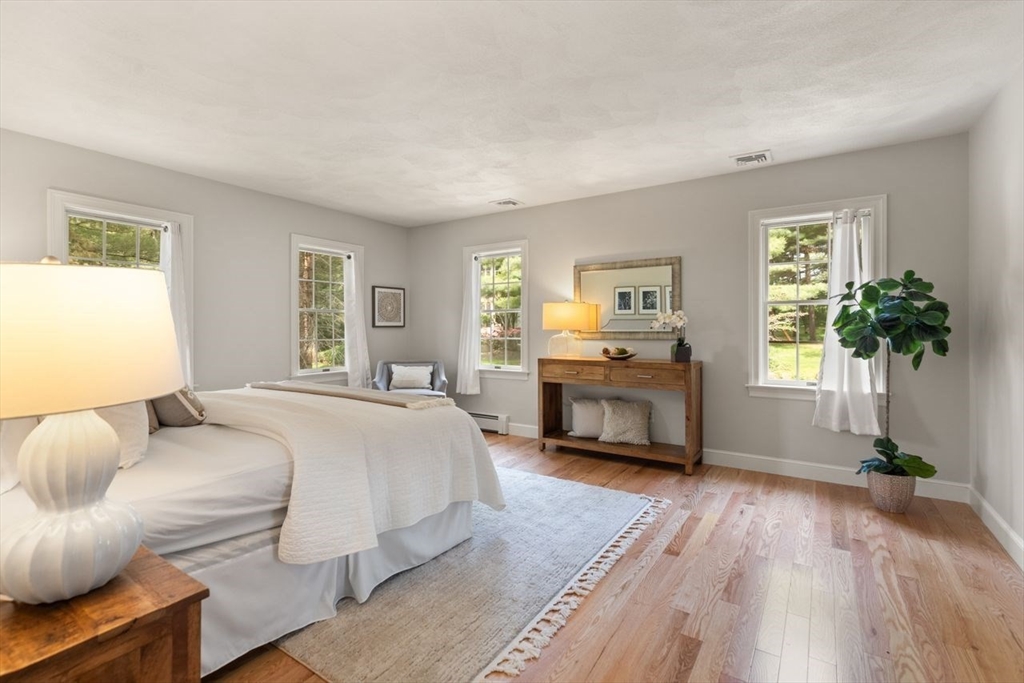 9 Mohawk Lane Lynnfield, MA 01940 - Photo 21 of 42 a spacious bedroom with a bed and a couch