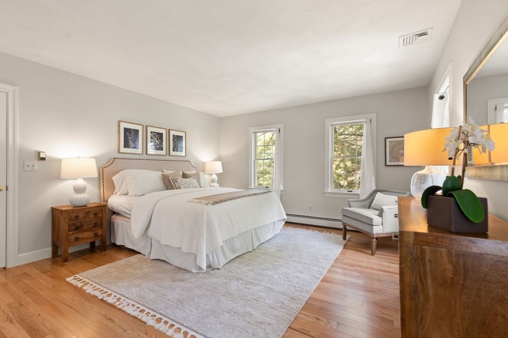 9 Mohawk Lane Lynnfield, MA 01940 - Photo 22 of 42 a spacious bedroom with a bed a lamp on table and a window