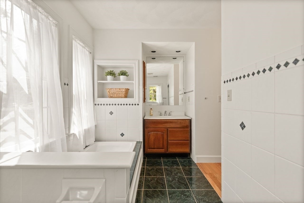 9 Mohawk Lane Lynnfield, MA 01940 - Photo 23 of 42 a bathroom with a tub sink and mirror