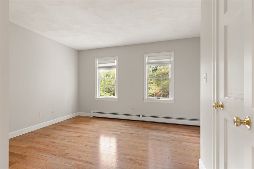 9 Mohawk Lane Lynnfield, MA 01940 - Photo 25 of 42 an empty room with wooden floor and windows