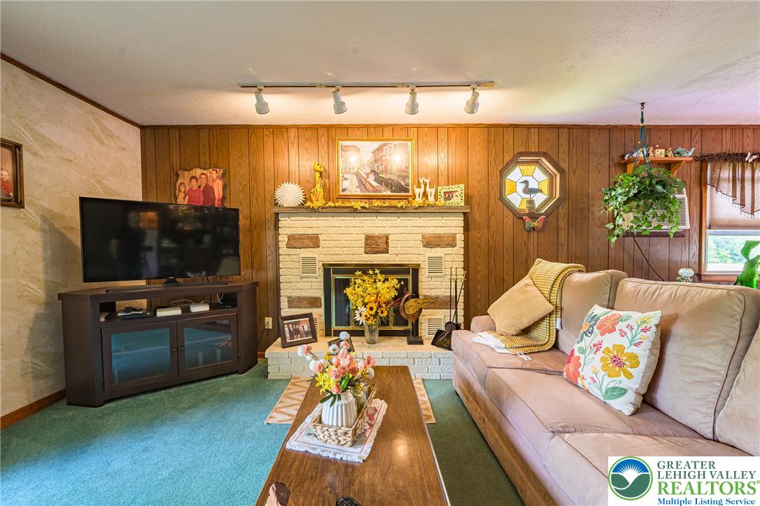 678 Interchange Road Kresgeville, PA 18333 - Photo 21 of 45 A classic fireplace with a brick facade creates a warm focal point in this inviting gathering space.